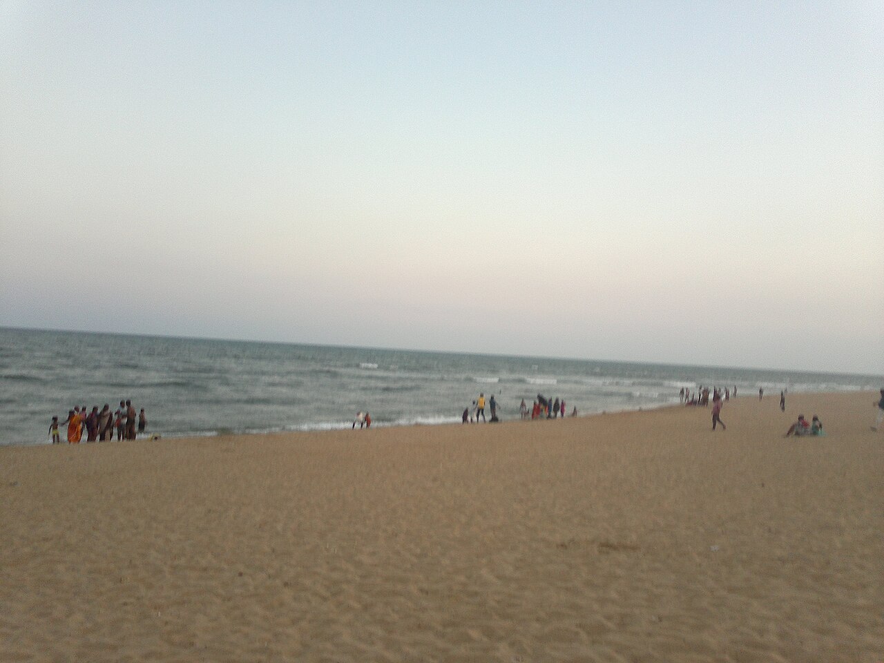 Pilgrims wading into the sea on the Tiruchendur shore