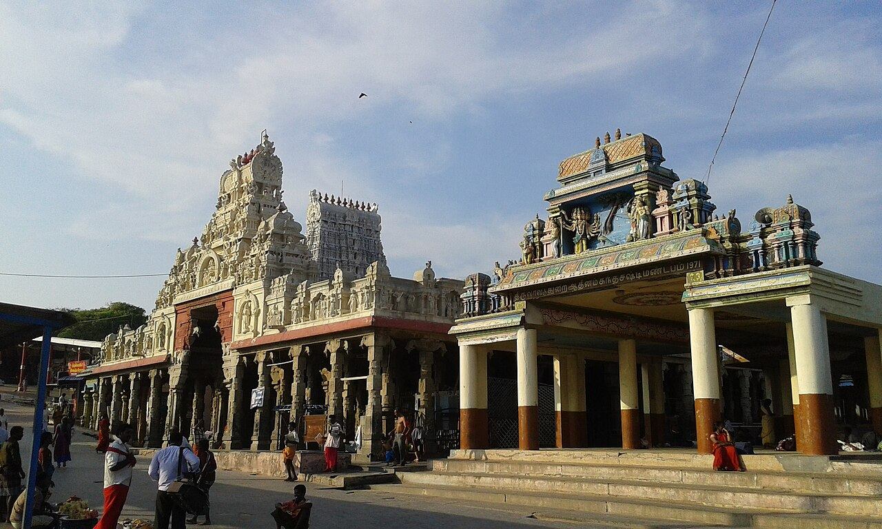 The mandapams and gopurams at the entrance of Tiruchendur Murugan Temple under a blue sky